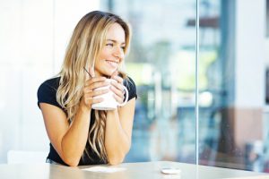 lady relaxing in clean home with cup of coffee